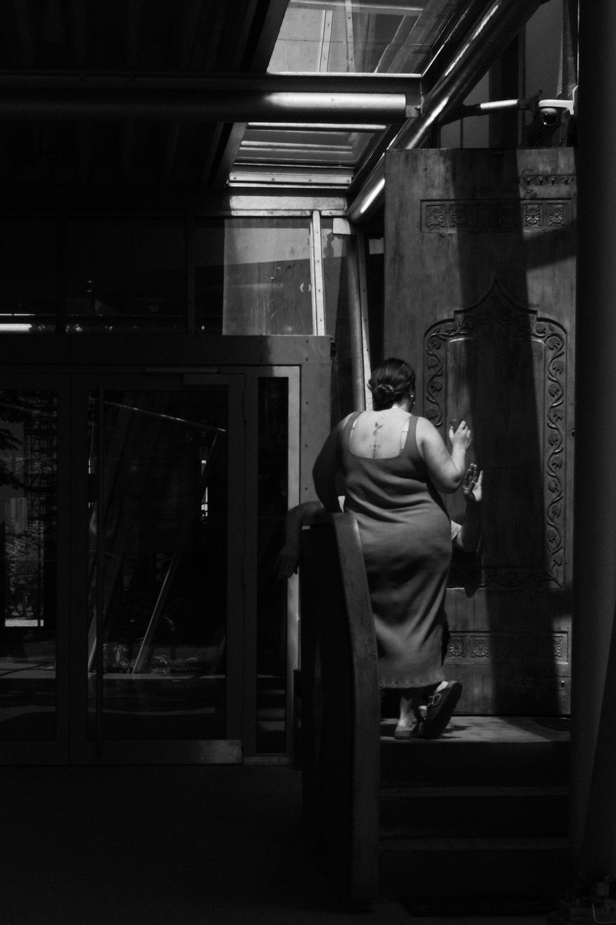 Woman walking through a dark passage
